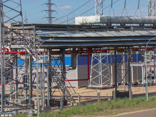 Metal constructions of an industrial enterprise. High-voltage power wires. Road lighting lanterns....