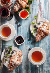 breakfast, croissant and jam, on a blue wood table