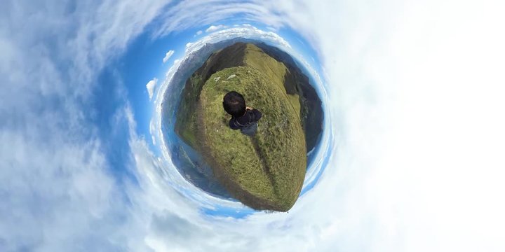 Top view of a man hiking in the mountains over Lake Como, tiny planet