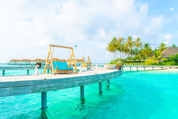 sofa swing with tropical Maldives resort and sea background