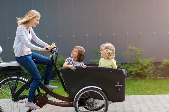 Mother and children having a ride with cargo bike