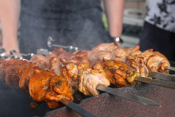 Shish kebab of the pork with the mix of spices on skewers on the old grill. Meat roasted on fire barbecue kebabs on the grill