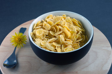 corn flakes on wooden table at morning with spoon 