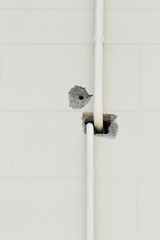 Holes in on the concrete wall with water pipes line, hole, drill the wrong hole for the pipe line