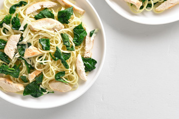 Spaghetti with spinach leaves, grilled chicken breast and cheese