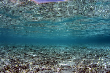 Underwater background. Clear blue ocean. Half water, split. Diving, snorkeling, swimming. Tulamben, Bali, Indonesia.