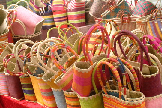 Colorful straw bags on market stall