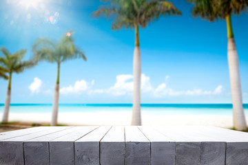 Table background of free space for your decoration and summer palms with sea 