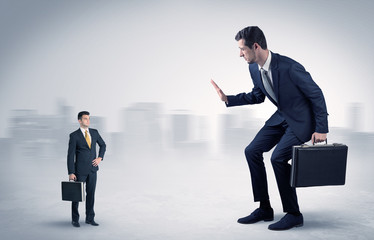 Giant businessman being afraid of small serious executor with suitcase
