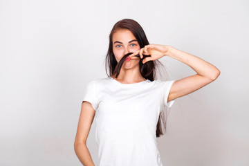 Young beautiful woman with a mustache from their hair