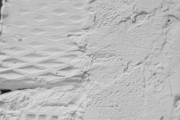 brick wall white color, rough plaster, macro, fragment