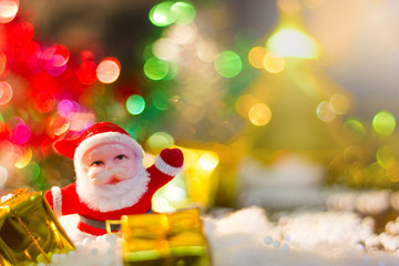 Cute Santa Claus With gold gift box and blur from the Christmas lights.