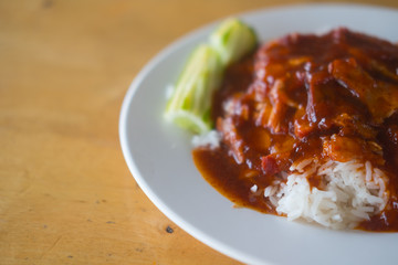 Barbecued red pork in sauce with rice.