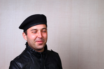 A cool rocker in a black leather jacket looks up, narrowing his eyes against the blurred background...