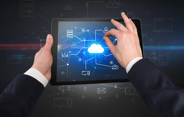 First person view of a hand using tablet with cloud office concept

