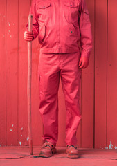 man in red clothes and walking stick