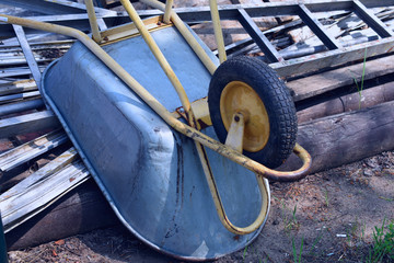 wheelbarrow turned upside down on a pile of building materials