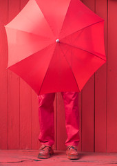 man in red clothes and red umbrella