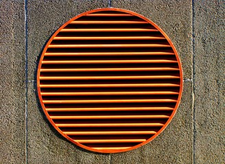 Abstract Geometric Architecture Background. Orange Circle Vent on City Street.