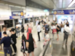 blurred image of Crowded station with people and passenger standing, walking and waiting for pick and choose the best public transport during rush hour in Bangkok city.