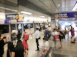 blurred image of Crowded station with people and passenger standing, walking and waiting for pick and choose the best public transport during rush hour in Bangkok city.