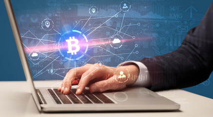 Fototapeta na wymiar Hand checking on laptop global bitcoin exchange rate concept 