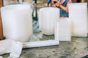 Food wrap in a roll on the table in a cafe. Disposable plastic tableware and food film for takeaway...