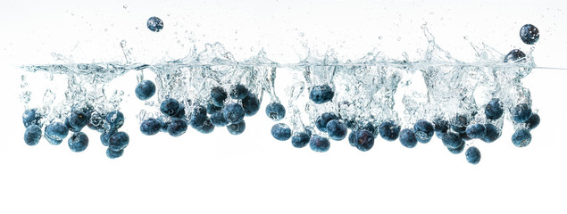 Blueberries sinking underwater, panorama