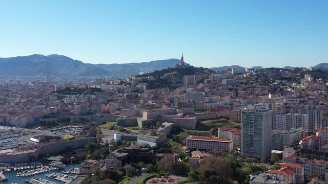 Marseille Vieux Port aerial back traveling basilic notre dame de la garde in background