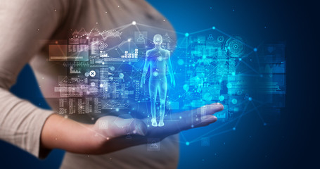 Young person holding hologram projection displaying health related graphs and symbols
