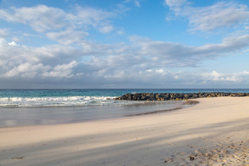An early morning view of a sandy beach, on the Caribbean island of Barbados