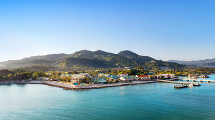 Fototapeta na wymiar Panorama of tropical resort Amber Cove with pier for cruise ships and resort in the morning