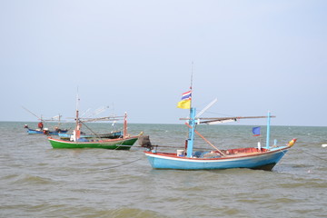 Naklejka na ściany i meble Fishing boat anchor on the beach