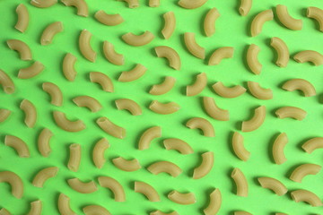 Texture of pasta in the form of an arc on a green background