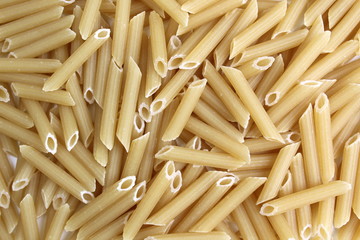 texture of pasta in the form of a pen on a red backgroun