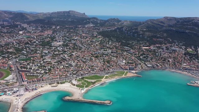 Aerial Marseille south districts sunny day Prado beach Calanques National park  in background