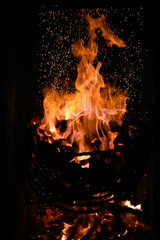 Fire flames with sparks on black background