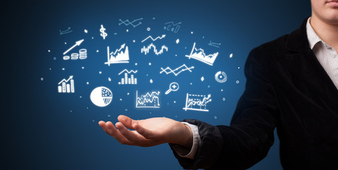 Hand holding application icons and symbols in her hand
