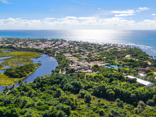 Aerial view Praia do Forte, Bahia, Brazil.  Beach and  clear sea water with small waves and palm trees forest .Travel tropical concept