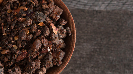 Bowl of Myrrh on a Dark Wood Table