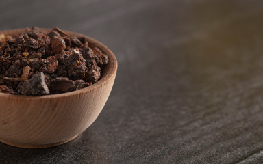 Bowl of Myrrh on a Dark Wood Table