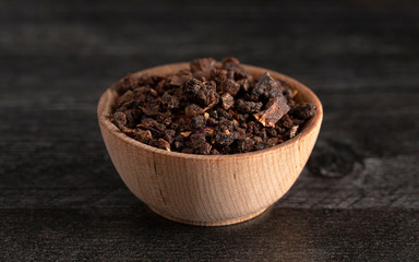 Bowl of Myrrh on a Dark Wood Table