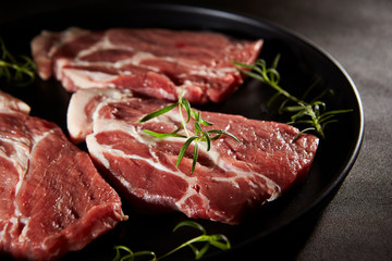 Fresh raw steak meat with rosemary