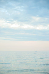 Obraz premium Seascape with sea horizon and blue sky. Background. Painterly seascape scene with relaxing sunset colours.