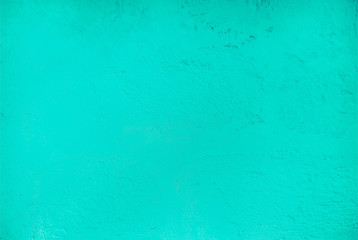 Textured relief plastered painted wall brightly aquamarine color