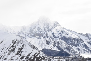 Fototapeta na wymiar Mt Kazbek Shrouded by Snow Clouds, Georgia