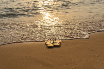 Slipper on the peaceful beach in the sunset