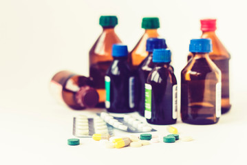 Medicine bottles, pills or capsules blister pack on white background with copy space for text, retro concept closeup.