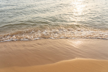 Fototapeta na wymiar Peaceful beach with some waves in sunny day