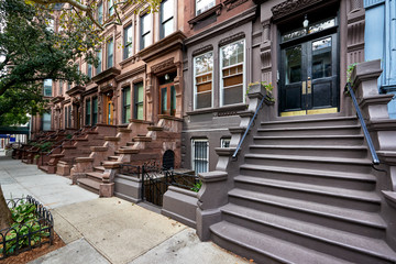 Fototapeta na wymiar a view of a row of historic brownstones in an iconic neighborhood of Manhattan, New York City